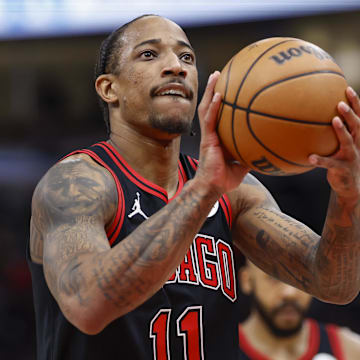 Dec 30, 2023; Chicago, Illinois, USA; Chicago Bulls forward DeMar DeRozan (11) shoots a free throw against the Philadelphia 76ers during the first half at United Center. Mandatory Credit: Kamil Krzaczynski-Imagn Images