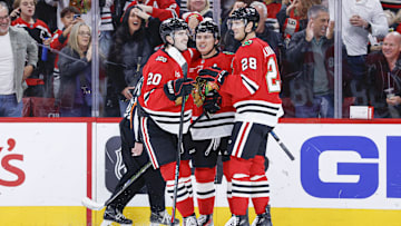 Nov 18, 2025; Chicago, Illinois, USA; Chicago Blackhawks center Connor Bedard (98) celebrates with teammates after scoring against the Calgary Flames during the second period at United Center. Mandatory Credit: Kamil Krzaczynski-Imagn Images