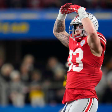 Dec 29, 2023; Arlington, Texas, USA; Ohio State Buckeyes defensive end Jack Sawyer (33) celebrates his sack of Missouri Tigers quarterback Brady Cook (12) in the third quarter during the Goodyear Cotton Bowl Classic at AT&T Stadium.