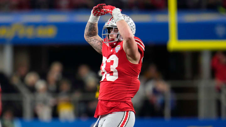 Dec 29, 2023; Arlington, Texas, USA; Ohio State Buckeyes defensive end Jack Sawyer (33) celebrates his sack of Missouri Tigers quarterback Brady Cook (12) in the third quarter during the Goodyear Cotton Bowl Classic at AT&T Stadium.