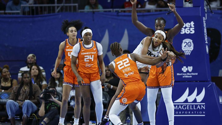 Aug 23, 2025; Chicago, Illinois, USA; Connecticut Sun guard Saniya Rivers (22) battles for the ball with Chicago Sky forward Angel Reese (5) during the first half at Wintrust Arena.