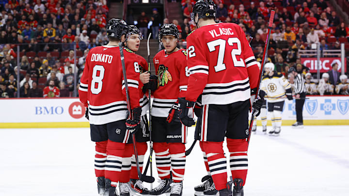 Dec 4, 2024; Chicago, Illinois, USA; Chicago Blackhawks center Connor Bedard (98) talks to teammates during the first period against the Boston Bruins at United Center. Mandatory Credit: Kamil Krzaczynski-Imagn Images