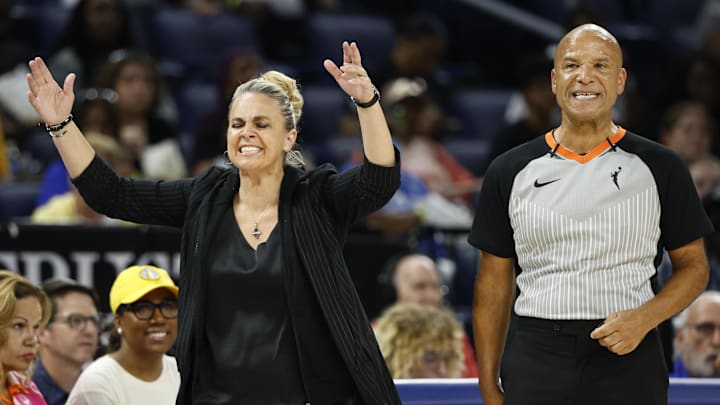 Aug 25, 2024; Chicago, Illinois, USA; Las Vegas Aces head coach Becky Hammon (L) argues a call against her team with official Tim Greene (R) during the first half of a basketball game against the Chicago Sky at Wintrust Arena. Mandatory Credit: Kamil Krzaczynski-Imagn Images