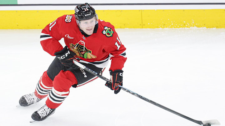 Jan 12, 2026; Chicago, Illinois, USA; Chicago Blackhawks center Oliver Moore (11) looks to pass the puck against the Edmonton Oilers during the first period at United Center. Mandatory Credit: Kamil Krzaczynski-Imagn Images