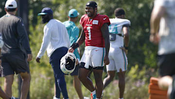Miami Dolphins quarterback Tua Tagovailoa (1) walks on the field during joint training camp practice with the Chicago Bears ahead of the preseason opener.