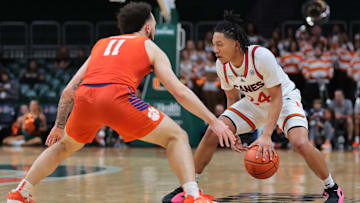 Dec 7, 2024; Coral Gables, Florida, USA; Miami Hurricanes guard Nijel Pack (24) dribbles the basketball as Clemson Tigers guard Jaeden Zackery (11) defends during the second half at Watsco Center. Mandatory Credit: Sam Navarro-Imagn Images