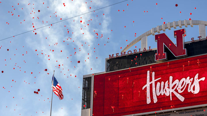 Nebraska fans let red balloons loose after the first touchdown of the game against Colorado.