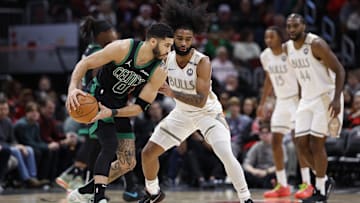 Dec 21, 2024; Chicago, Illinois, USA; Chicago Bulls guard Coby White (0) defends against Boston Celtics forward Jayson Tatum (0)