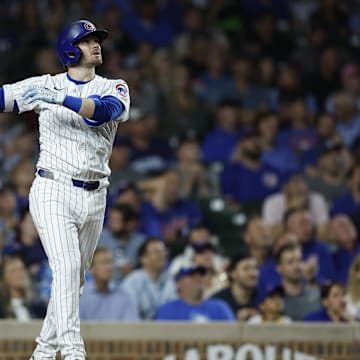 Sep 17, 2024; Chicago, Illinois, USA; Chicago Cubs outfielder Ian Happ hits a solo home run against the Oakland Athletics.