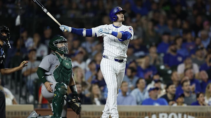 Sep 17, 2024; Chicago, Illinois, USA; Chicago Cubs outfielder Ian Happ hits a solo home run against the Oakland Athletics.