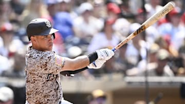 Aug 3, 2025; San Diego, California, USA; San Diego Padres catcher Freddy Fermin (54) hits a single during the seventh inning against the St. Louis Cardinals at Petco Park. Mandatory Credit: Denis Poroy-Imagn Images
