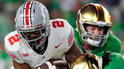 Sep 23, 2023; South Bend, Indiana, USA; Ohio State Buckeyes wide receiver Emeka Egbuka (2) makes a catch against Notre Dame Fighting Irish cornerback Cam Hart (5) and Notre Dame Fighting Irish linebacker JD Bertrand (27) during the fourth quarter of their game at Notre Dame Stadium.