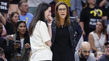 Jul 27, 2025; Chicago, Illinois, USA; Indiana Fever head coach Stephanie White (R) talks to injured guard Caitlin Clark (L) before a basketball game against the Chicago Sky at United Center. Mandatory Credit: Kamil Krzaczynski-Imagn Images