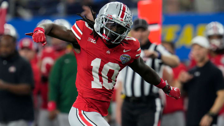 Dec 29, 2023; Arlington, Texas, USA; Ohio State Buckeyes cornerback Denzel Burke (10) celebrates a tackle of Missouri Tigers quarterback Brady Cook (12) on a run in the first quarter during the Goodyear Cotton Bowl Classic at AT&T Stadium.