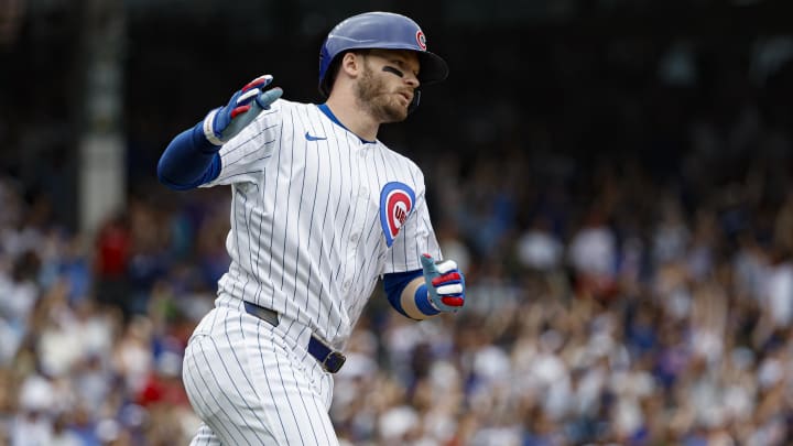 Jul 4, 2024; Chicago, Illinois, USA; Chicago Cubs outfielder Ian Happ (8) rounds the bases after hitting a three-run home run against the Philadelphia Phillies during the fourth inning at Wrigley Field.