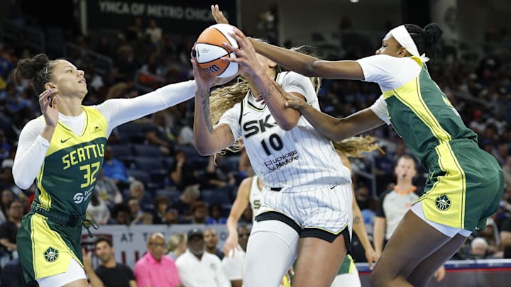 Jul 24, 2025; Chicago, Illinois, USA; Chicago Sky center Kamilla Cardoso (10) drives to the basket against Seattle Storm forward Alysha Clark (32) and center Dominique Malonga (14) during the first half at Wintrust Arena. Mandatory Credit: Kamil Krzaczynski-Imagn Images