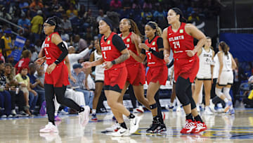Atlanta Dream players walk back to the bench during the second half of a WNBA game against the Chicago Sky at Wintrust Arena. 