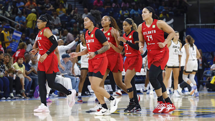 Atlanta Dream players walk back to the bench during the second half of a WNBA game against the Chicago Sky at Wintrust Arena. 