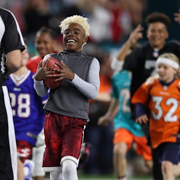 Feb 2, 2020; Miami Gardens, Florida, USA; Maxwell    Bunchie    Young presents the game ball to referee Bill Vinovich (52) prior to the Kansas City Chiefs playing against the San Francisco 49ers in Super Bowl LIV at Hard Rock Stadium. Mandatory Credit: Matthew Emmons-Imagn Images