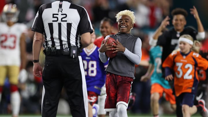 Feb 2, 2020; Miami Gardens, Florida, USA; Maxwell    Bunchie    Young presents the game ball to referee Bill Vinovich (52) prior to the Kansas City Chiefs playing against the San Francisco 49ers in Super Bowl LIV at Hard Rock Stadium. Mandatory Credit: Matthew Emmons-Imagn Images
