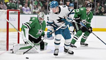 Nov 20, 2024; Dallas, Texas, USA; San Jose Sharks left wing Fabian Zetterlund (20) attempts to poke the puck past Dallas Stars goaltender Jake Oettinger (29) during the third period at the American Airlines Center. Mandatory Credit: Jerome Miron-Imagn Images
