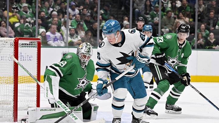 Nov 20, 2024; Dallas, Texas, USA; San Jose Sharks left wing Fabian Zetterlund (20) attempts to poke the puck past Dallas Stars goaltender Jake Oettinger (29) during the third period at the American Airlines Center. Mandatory Credit: Jerome Miron-Imagn Images