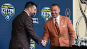 Ohio State Buckeyes head coach Ryan Day and Texas Longhorns head coach Steve Sarkisian shake hands following a press conference at AT&T Stadium prior to the College Football Playoff semifinal at the Cotton Bowl Classic in Arlington, Texas on Jan. 9, 2025.