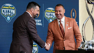 Ohio State Buckeyes head coach Ryan Day and Texas Longhorns head coach Steve Sarkisian shake hands following a press conference at AT&T Stadium prior to the College Football Playoff semifinal at the Cotton Bowl Classic in Arlington, Texas on Jan. 9, 2025.