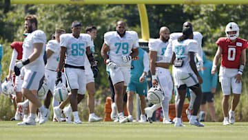 Miami Dolphins offensive tackle Larry Borom (79) walks on the field during joint training camp practice with the Chicago Bears ahead of the preseason opener.