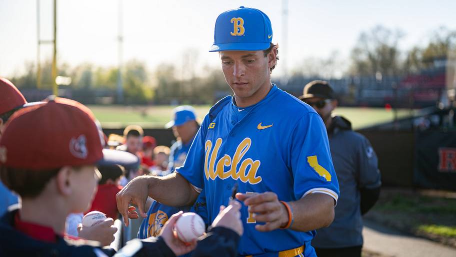 UCLA shortstop Roch Cholowsky signs autographs for young fans