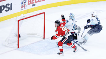 Nov 20, 2025; Chicago, Illinois, USA; Chicago Blackhawks center Connor Bedard (98) reacts to a lack of call against Seattle Kraken defenseman Ryan Lindgren (55) during the third period at United Center. Mandatory Credit: Kamil Krzaczynski-Imagn Images