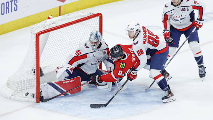 Dec 17, 2024; Chicago, Illinois, USA; Chicago Blackhawks center Ryan Donato (8) scores a goal against Washington Capitals goaltender Logan Thompson (48) during the third period at United Center. Mandatory Credit: Kamil Krzaczynski-Imagn Images