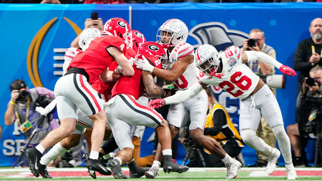 Dec 31, 2022; Atlanta, Georgia, USA; Georgia Bulldogs running back Kendall Milton (2) scores a rushing touchdown against Ohio State Buckeyes safety Sonny Styles (20) during the second quarter of the Peach Bowl in the College Football Playoff semifinal at Mercedes-Benz Stadium.