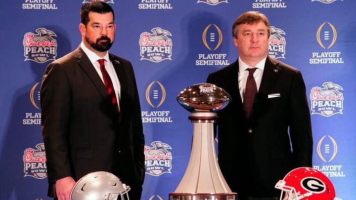 Dec 30, 2022; Atlanta, GA, USA; Ohio State Buckeyes head coach Ryan Day and Georgia Bulldogs head coach Kirby Smart pose for a photo during the coaches Peach Bowl press conference at the Westin Peachtree Plaza.