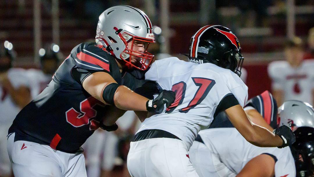 Morton lineman Soren Fifer, left, protects the quarterback in the second half of their Week 4 high school football game against Metamora on Friday, Sept. 19, 2025 in Morton. The Redbirds defeated the Potters 43-40.