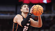 Nov 27, 2025; Chicago, Illinois, USA; Oklahoma State Cowboys center Parsa Fallah (22) shoots a free throw against Northwestern Wildcats during the first half at United Center. Mandatory Credit: Kamil Krzaczynski-Imagn Images