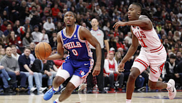 Dec 8, 2024; Chicago, Illinois, USA; Philadelphia 76ers guard Tyrese Maxey (0) drives to the basket against Chicago Bulls guard Ayo Dosunmu (11)