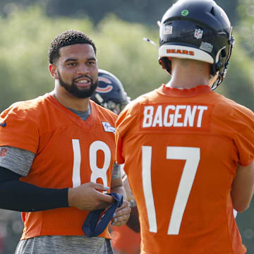 Caleb Williams goes over a few things with backup QB Tyson Bagent during training camp at Hals Hall.