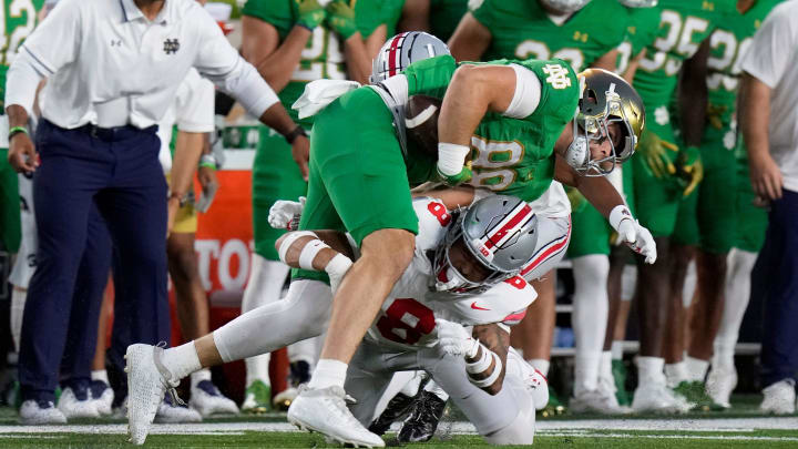 Sep 23, 2023; South Bend, Indiana, USA; Ohio State Buckeyes safety Lathan Ransom (8) tackles Notre Dame Fighting Irish tight end Mitchell Evans (88) after a catch during the first quarter of their game at Notre Dame Stadium.