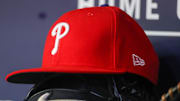 May 26, 2023; Atlanta, Georgia, USA; A detailed view of a Philadelphia Phillies hat and glove on the bench against the Atlanta Braves in the seventh inning at Truist Park. 
