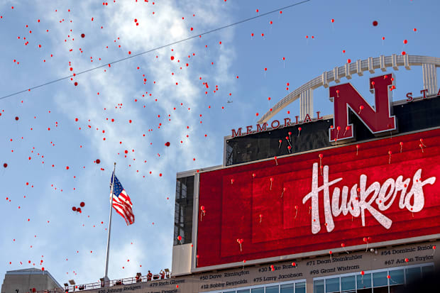 Nebraska fans let red balloons loose after the first touchdown of the game against Colorado.