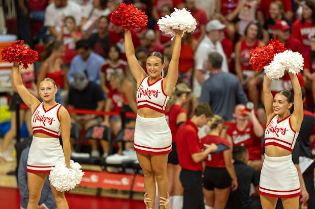 Nebraska cheerleaders pump up the crowd from up high during the Red-White Scrimmage on Saturday.