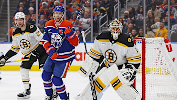 Edmonton Oilers forward Connor McDavid (97) looks for a loose puck in front of Boston Bruins goaltender Jeremy Swayman (1)