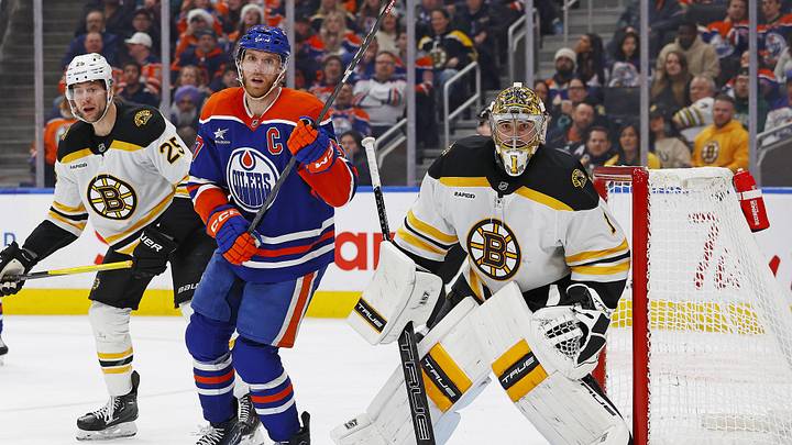 Edmonton Oilers forward Connor McDavid (97) looks for a loose puck in front of Boston Bruins goaltender Jeremy Swayman (1)