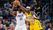 Mar 18, 2023; Indianapolis, Indiana, USA; Philadelphia 76ers center Joel Embiid (21) looks to pass the ball while  Indiana Pacers guard Andrew Nembhard (2) defends in the first quarter at Gainbridge Fieldhouse. Mandatory Credit: Trevor Ruszkowski-Imagn Images
