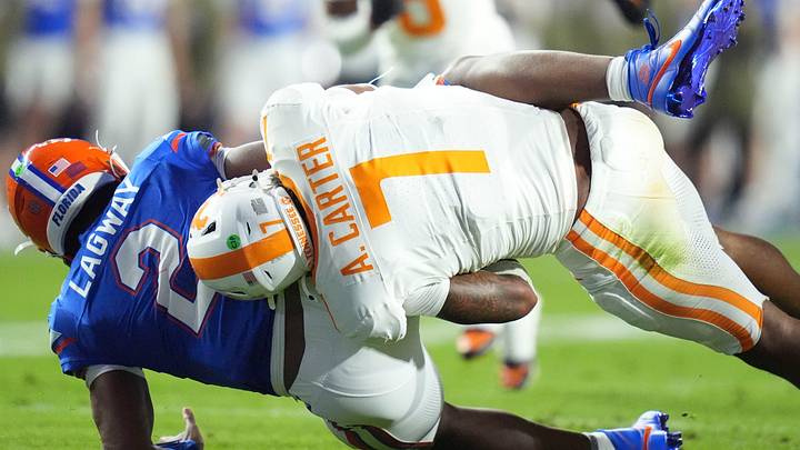 Tennessee linebacker Arion Carter (7) takes down Florida quarterback DJ Lagway (2) in an NCAA college football game on November 22, 2025, in Gainesville, Florida.