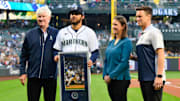 Seattle Mariners chairman John Stanton (left), President of Business Operations Catie Griggs (middle right) and president of baseball operations Jerry Dipoto (right) stand with reliever Andres Munoz before a game against the Los Angeles Angels on Sept. 11, 2023, at T-Mobile Park.