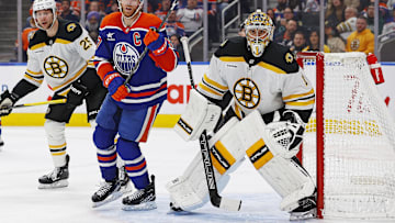 Dec 19, 2024; Edmonton, Alberta, CAN; Edmonton Oilers forward Connor McDavid (97) looks for a loose puck in front of Boston Bruins goaltender Jeremy Swayman (1)during the third period at Rogers Place. Mandatory Credit: Perry Nelson-Imagn Images