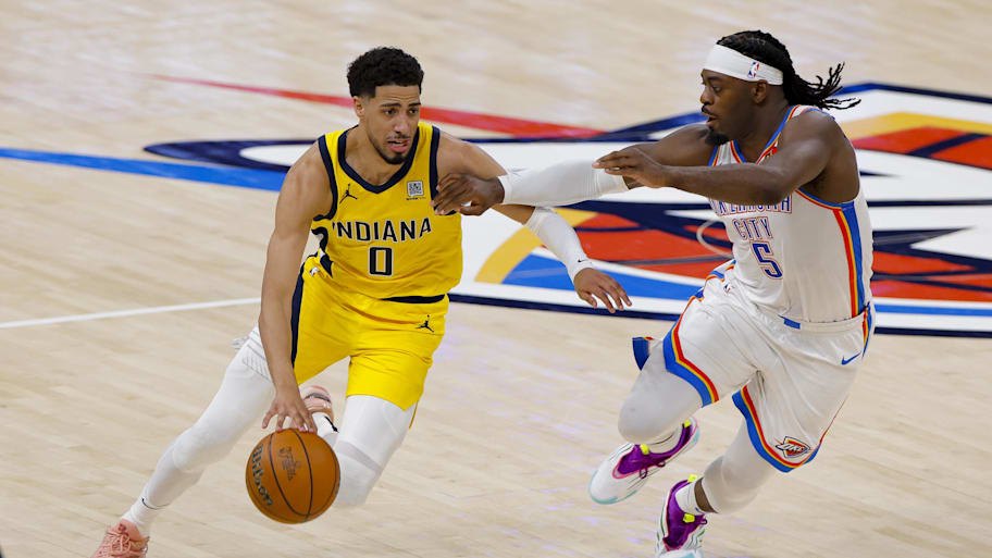 Indiana Pacers guard Tyrese Haliburton (0) drives to the basket past Oklahoma City Thunder guard Luguentz Dort (5) during the second quarter during game one of the 2025 NBA Finals at Paycom Center. | Alonzo Adams-Imagn Images