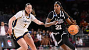 Mar 22, 2025; Los Angeles, California, USA; Mississippi State Bulldogs guard Debreasha Powe (21) drives to the basket past California Golden Bears forward Marta Suarez (7) during the first quarter of an NCAA Tournament game at Galen Center. Mandatory Credit: Robert Hanashiro-Imagn Images